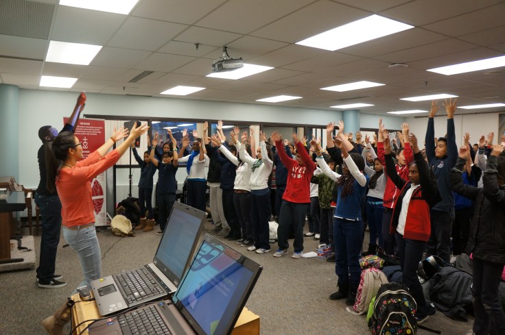 E-CSLIT Chair, Theresa Hoang and Co-op student, Stefan Ntansah lead the students in a Waving Flag dance.