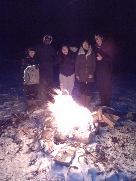 Mentors braving the cold to set up the fire